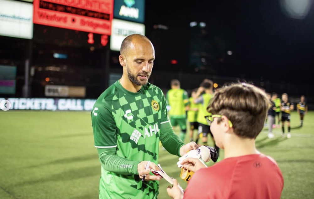 Gabriel Perrotta signing for a young fan